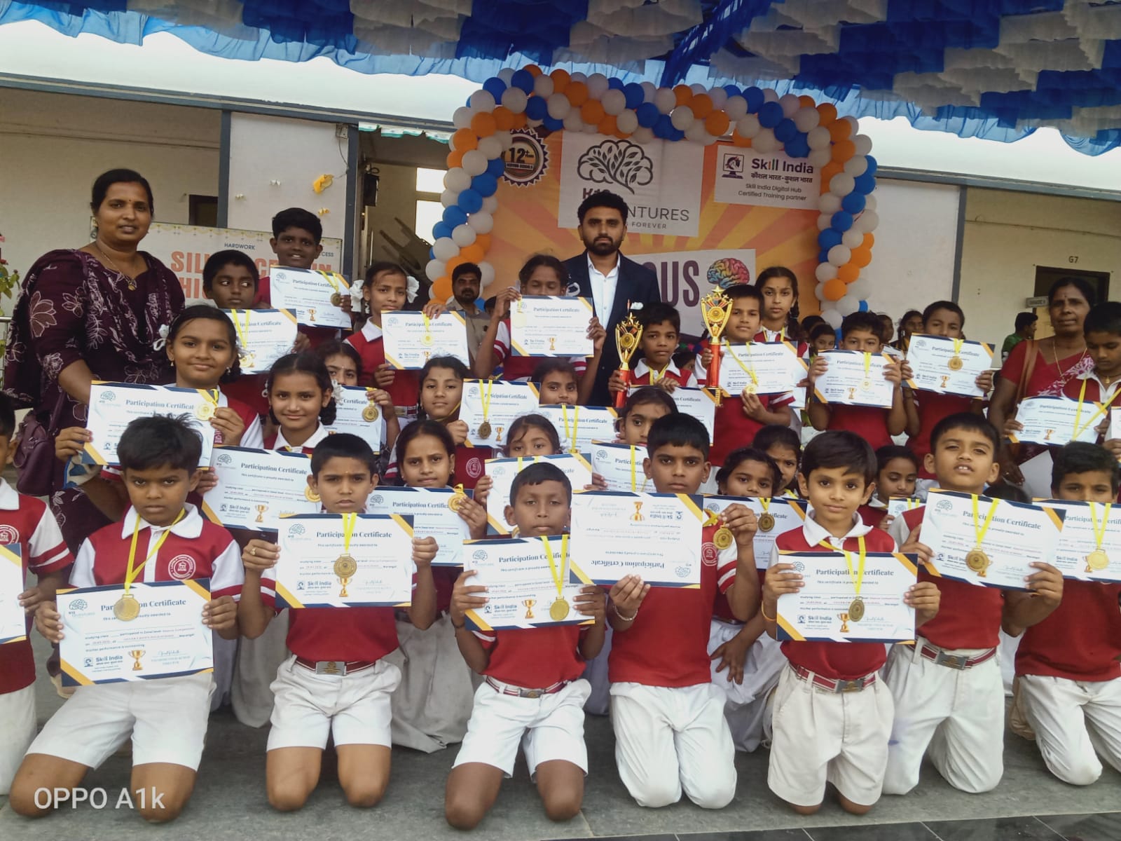 School children holding certificates and medals during an event