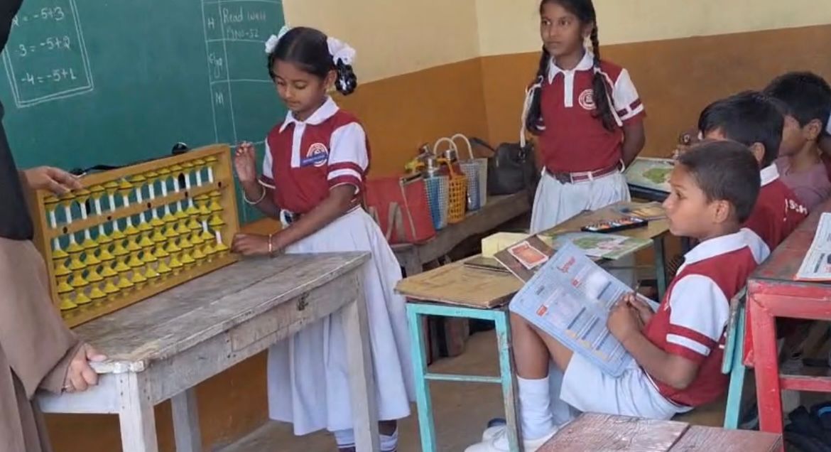 Young students using an abacus in class at Layola High School