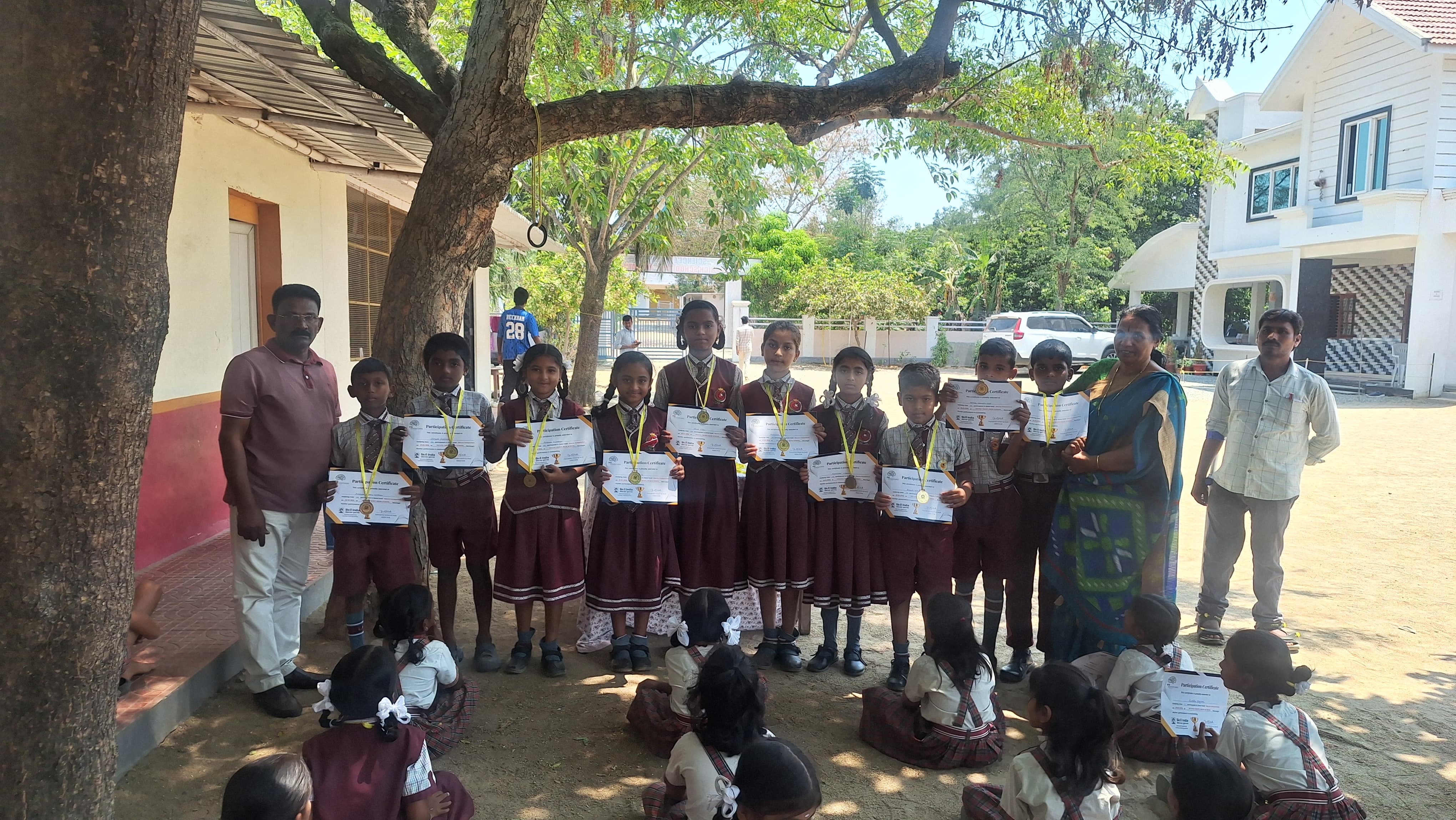 Students receiving certificates and medals during a school achievement event